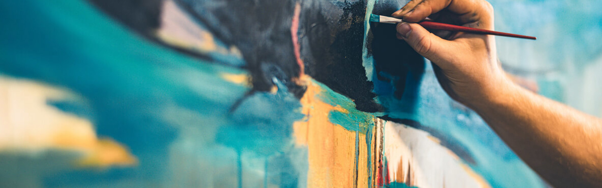 Someone painting on a canvas