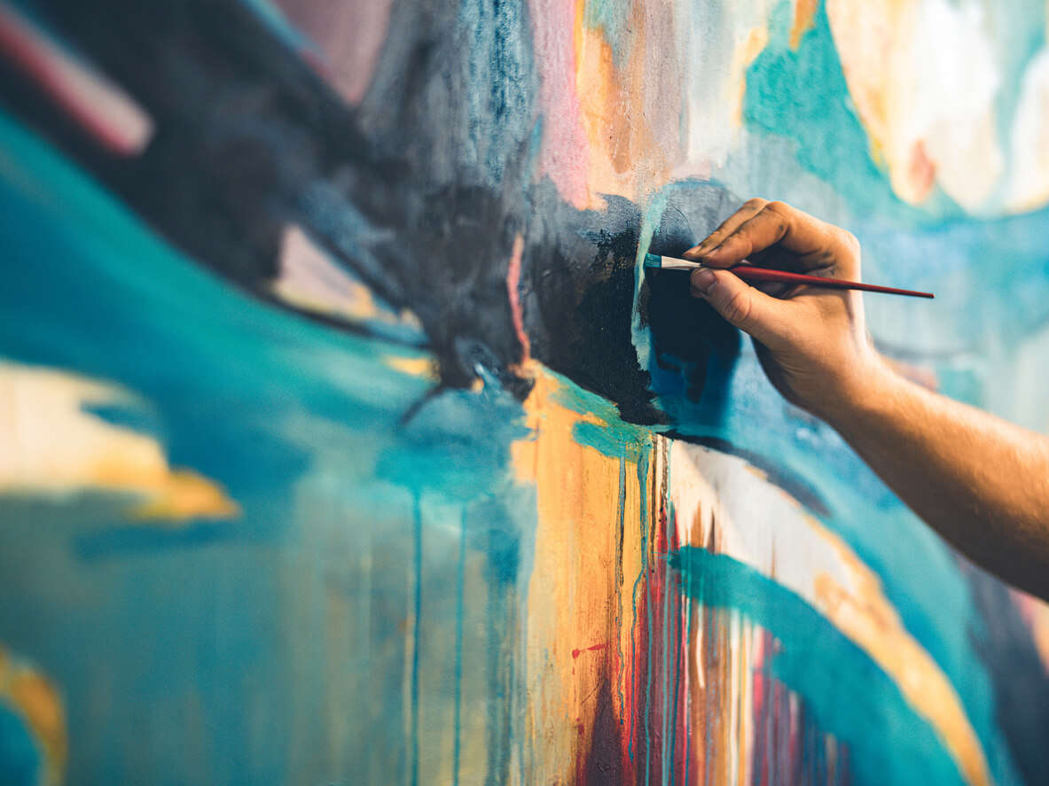 Someone painting on a canvas