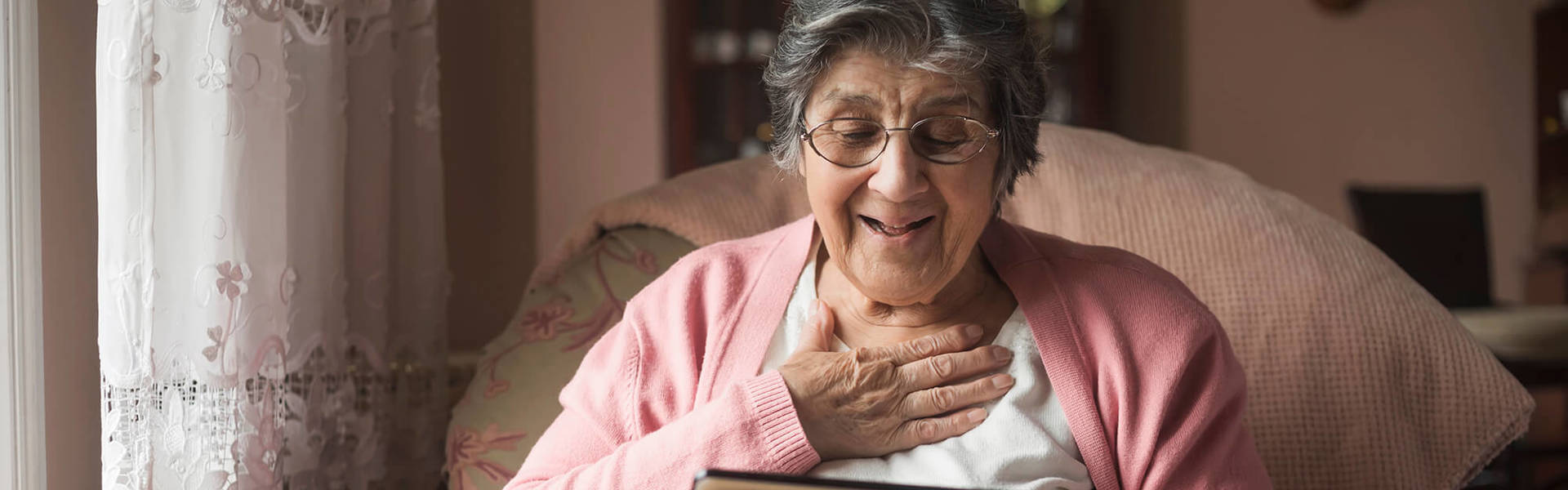 An older lady looking at a tablet 