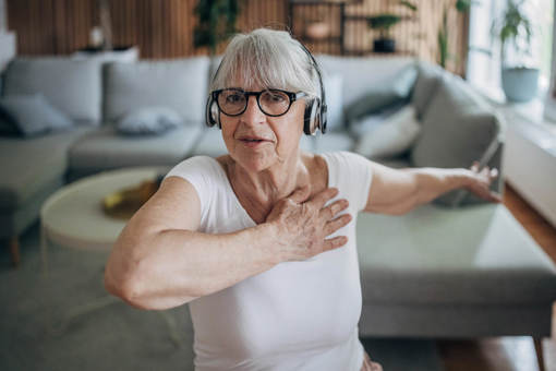 An older woman working out at home