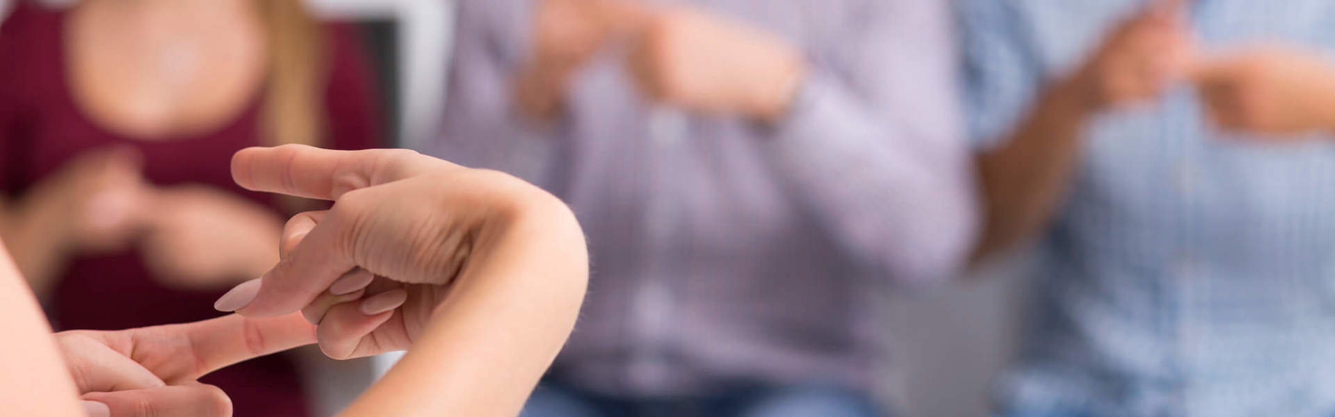 A close up of someone teaching sign language 