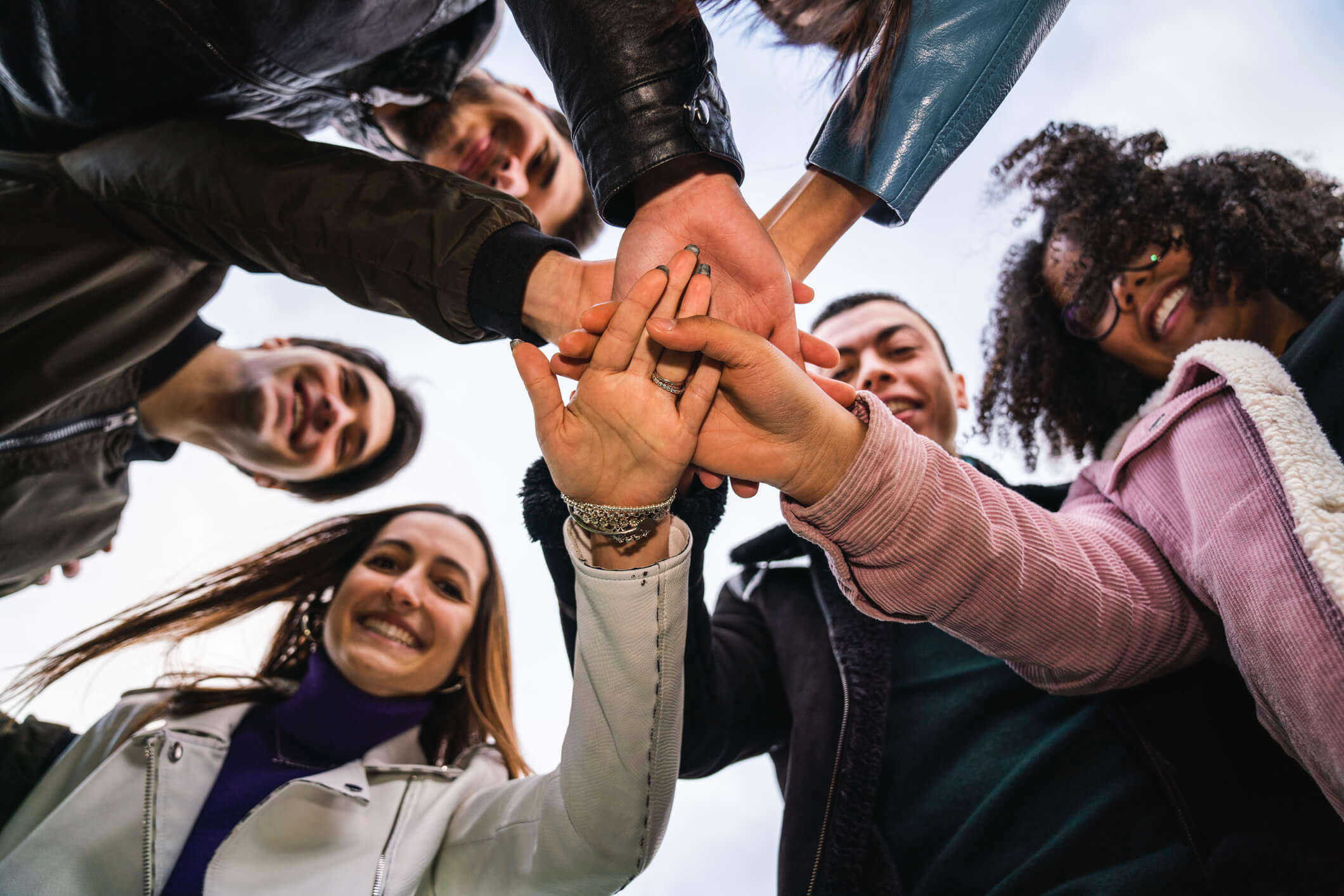 A group of supporters crossing hands