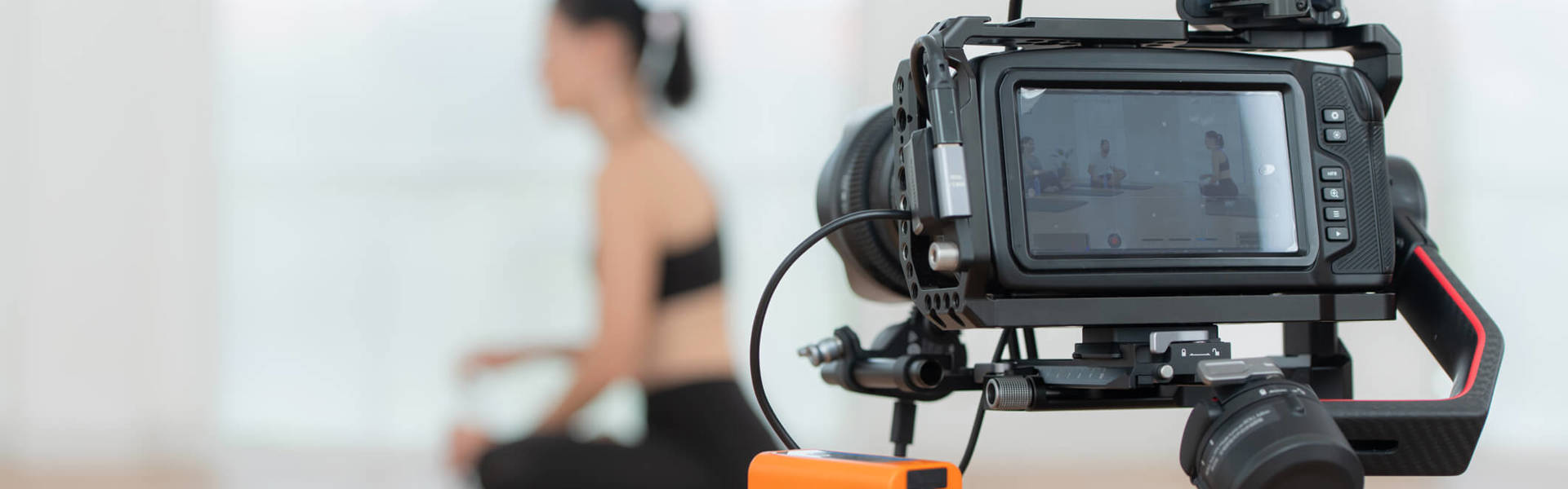 Someone being filmed holding a yoga class